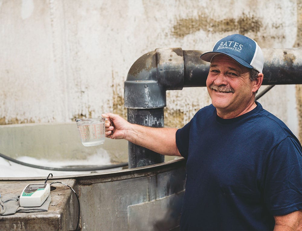 A Man Standing In Front Of A Barrel