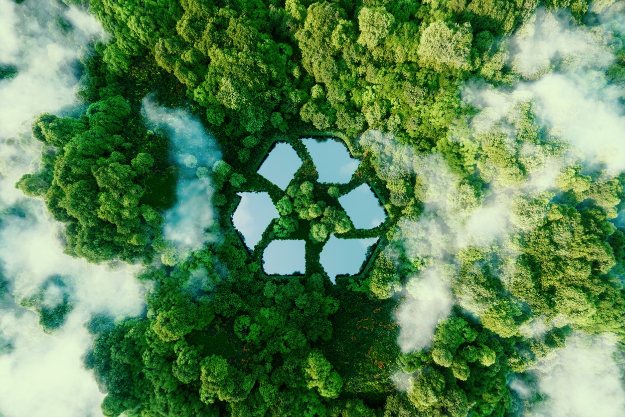 A Lake In The Shape Of A Recycling Sign In The Middle Of Untouched Nature