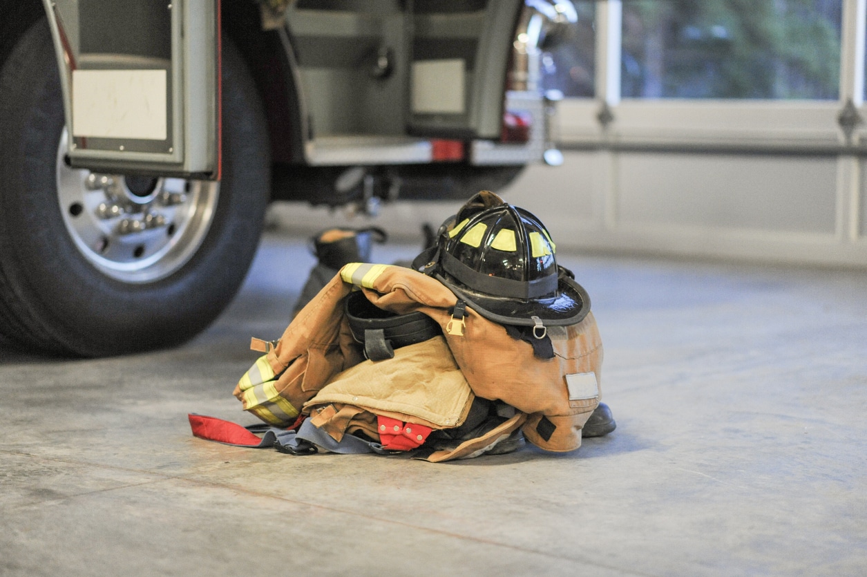 Firefighter Turnout Gear Stacked In A Pile In The Foreground