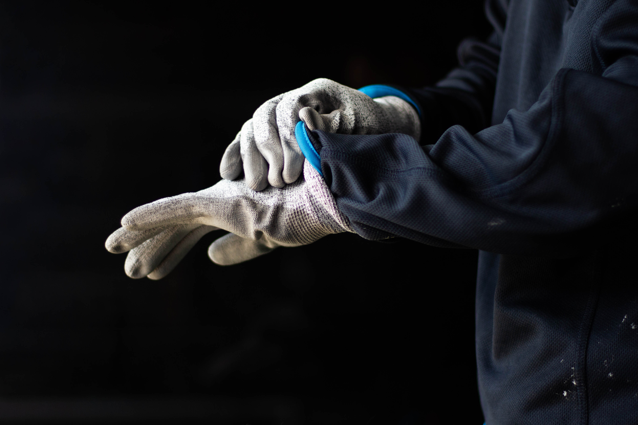 A Glass Worker Pulls On Cut-resistant Gloves Made Of Dyneema Fabric